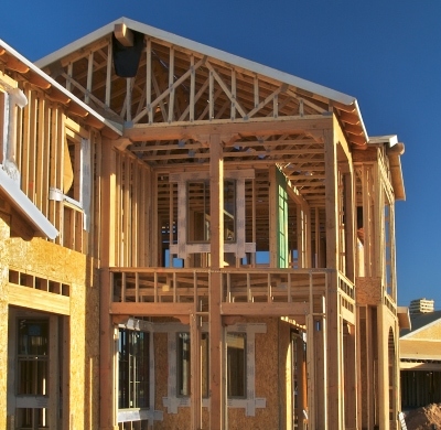 metal stamped connectors and fasteners in a wooden house frame under construction.